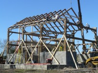 During restoration, this barn was erected on a five foot tall concrete wall to gain height on the gable end walls.  The concrete was then faced with stone, inside and out.